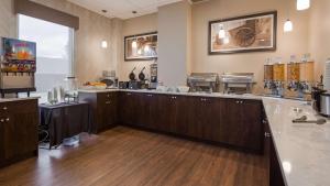 a large kitchen with wooden cabinets and a counter top at Best Western Airdrie in Airdrie