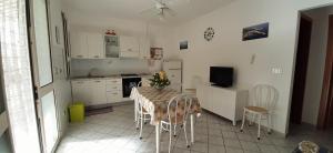 a kitchen with a table and chairs in a room at Il Faro di Anna in Leuca