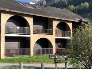 a building with arches and a sign in front of it at Studio Monêtier-les-Bains (Serre Chevalier) in Le Monêtier-les-Bains