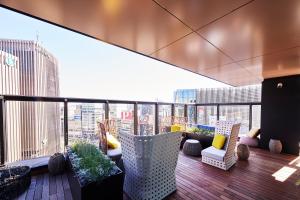 a balcony with a view of a city skyline at The Gate Hotel Tokyo by Hulic in Tokyo
