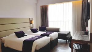 Premier Place Surabaya Airport客房内的一张或多张床位