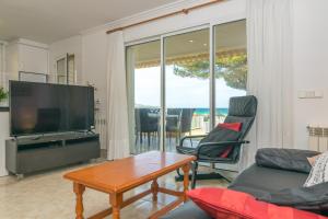 a living room with a television and a table and chairs at Chillvista in Playa de Muro