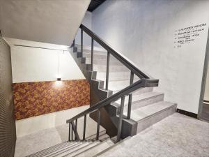a staircase in a building with a painting on the wall at Okinawa City Hotel in Okinawa City