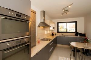 a kitchen with a sink and a table in it at Villa D'Aÿ-Champagne in Épernay +5 photos