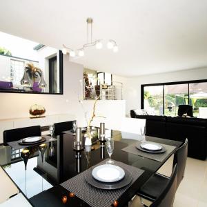 a dining room with a black table and black chairs at Villa D'Aÿ-Champagne in Épernay