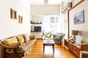 a living room with a couch and a table at Beautiful appartment under Akropolis! in Athens