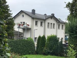 a large white house with a balcony at Stellwerk in Dahlem