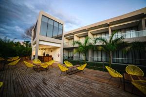 a group of chairs and tables in front of a building at Le Elementos Boutique Hotel in Lusaka