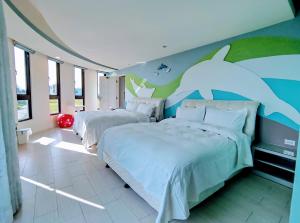 Postel nebo postele na pokoji v ubytování Shell Sand Homestay