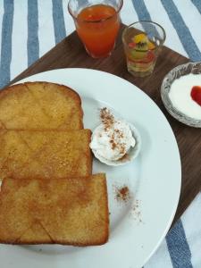a white plate with toast and a side of yogurt at B&B Forest Shima in Shima
