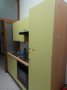 a green refrigerator in a kitchen with a stove at Il Gatto Con Gli Stivali in Florence