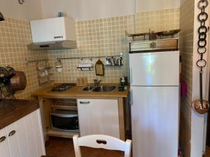 uma cozinha com um frigorífico branco e um lavatório em Elfoghiro' em Ateleta