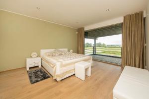 MannivaにあるGolf Villa near Tallinnのベッドと大きな窓のある寝室