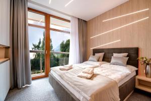 A bed or beds in a room at Apartment Luna Hrebienok C109