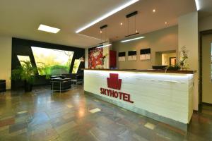 a restaurant with a swissmed counter in a lobby at SKYHOTEL Merseburg in Merseburg