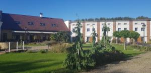 a large building with a tree in front of it at Statek 1738 in Všestudy