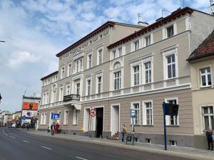 a large white building on the side of a street at Apartamenty Nowy Rynek in Bydgoszcz
