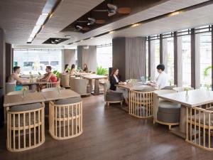 
a restaurant with tables and chairs in it at Solitaire Bangkok Sukhumvit 11 - SHA Extra Plus in Bangkok
