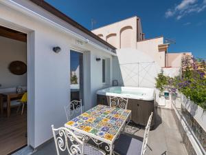 a small balcony with a table and chairs on a patio at "Bea's Terrace" - Private Jacuzzi and panoramic rooftop in the City Centre in Cagliari