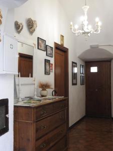 a kitchen with a dresser and a mirror on the wall at B&B Goriano Valli in Goriano Valli