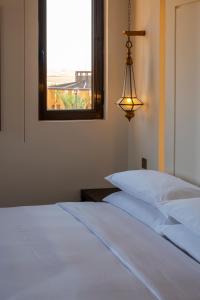a bedroom with a white bed and a window at Mysk Al Badayer Retreat in Sharjah