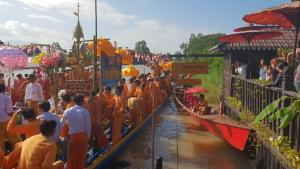 a crowd of people in orange robes standing in a parade at Thanakha Inle Hotel in Nyaungshwe Township