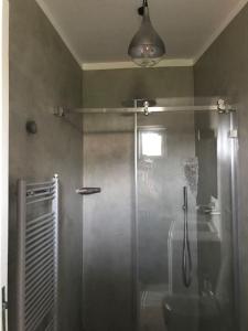 a bathroom with a shower with a glass door at Casa Isabella in Malfa