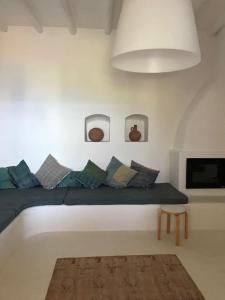 a room with a couch with pillows and a table at Casa Isabella in Malfa