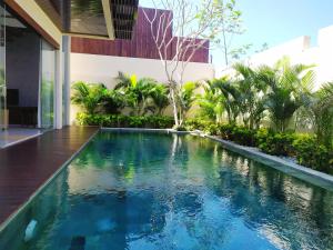 a swimming pool in the middle of a building at The Miracle Villa Nusa Dua in Nusa Dua