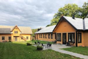 a building with tables and chairs in a yard at Stenholmens Gårdshotell in Linköping