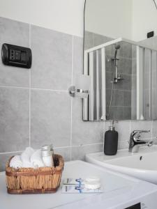 a bathroom with a basket of towels on a sink at Brand New Cinque Terre Cozy Flat in La Spezia +7 photos