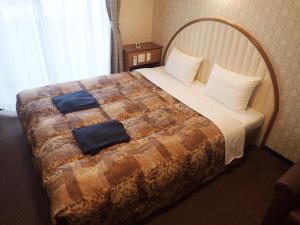 Postel nebo postele na pokoji v ubytování Castle Inn Komaki