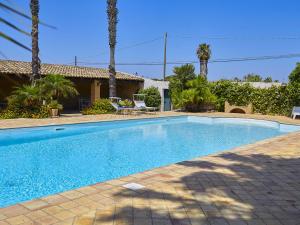 a swimming pool in front of a house at Lush Villa with Private Swimming Pool in Marsala Sicily in Marsala