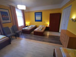 a room with two beds and a table and chairs at Apartment Sunside in Mýto