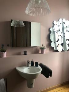 a bathroom with a sink and a mirror at back to school (rote Schule) in Andernach