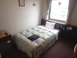 Postel nebo postele na pokoji v ubytování Castle Inn Komaki