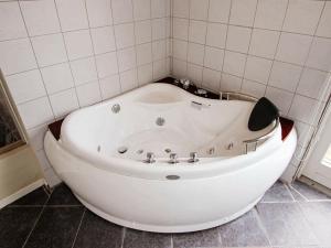 a white bath tub sitting in a bathroom at 10 person holiday home in Harbo re in Harboør