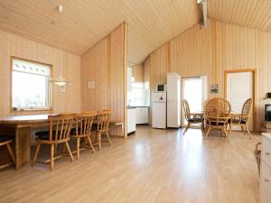 a kitchen and dining room with a table and chairs at Holiday home Harboøre XVI in Harboør