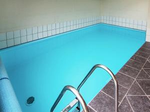 a swimming pool with blue water in a bathroom at 10 person holiday home in Harbo re in Harboør
