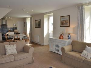a living room with two couches and a kitchen at Blackhill Farm Cottage in Perth +39 photos