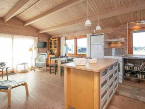 a large kitchen with a counter in a room at 8 person holiday home in Harbo re in Harboør