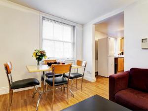 a living room filled with furniture and a table at Acorn - Bedford Place Apartments in London
