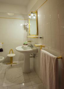 a bathroom with a sink and a mirror at Hotel Quadrifoglio in Cagliari