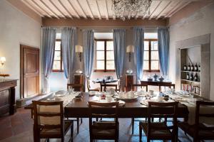 a dining room with a large wooden table and chairs at Palazzo Malaspina B&B in Tavarnelle in Val di Pesa