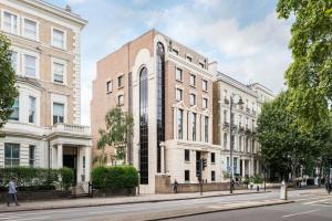 a large brick building on a city street at The Carlyle - Stunning Serviced Apartments in London