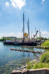 a boat is docked in a body of water at VakantieStudio 88 in Kamperland +33 photos