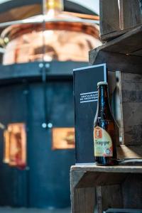 a bottle of beer sitting next to a box at VakantieStudio 88 in Kamperland