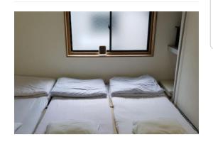 A bed or beds in a room at Kiyamachi Guesthouse
