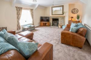 a living room with two couches and a fireplace at The Cross Keys in Esh