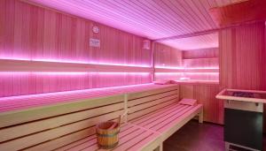 a sauna with pink lights on the walls at Country Hotel Timmendorfer Strand in Timmendorfer Strand